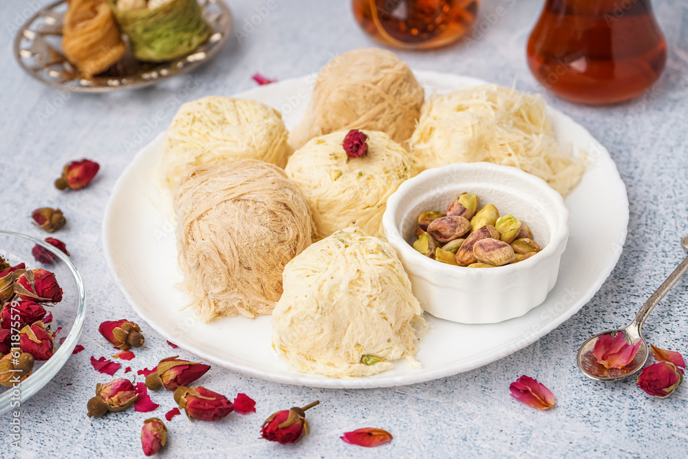 Plate with tasty Turkish Pismaniye on light background