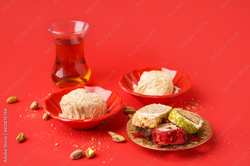 Tasty Turkish Pismaniye and delight on red background