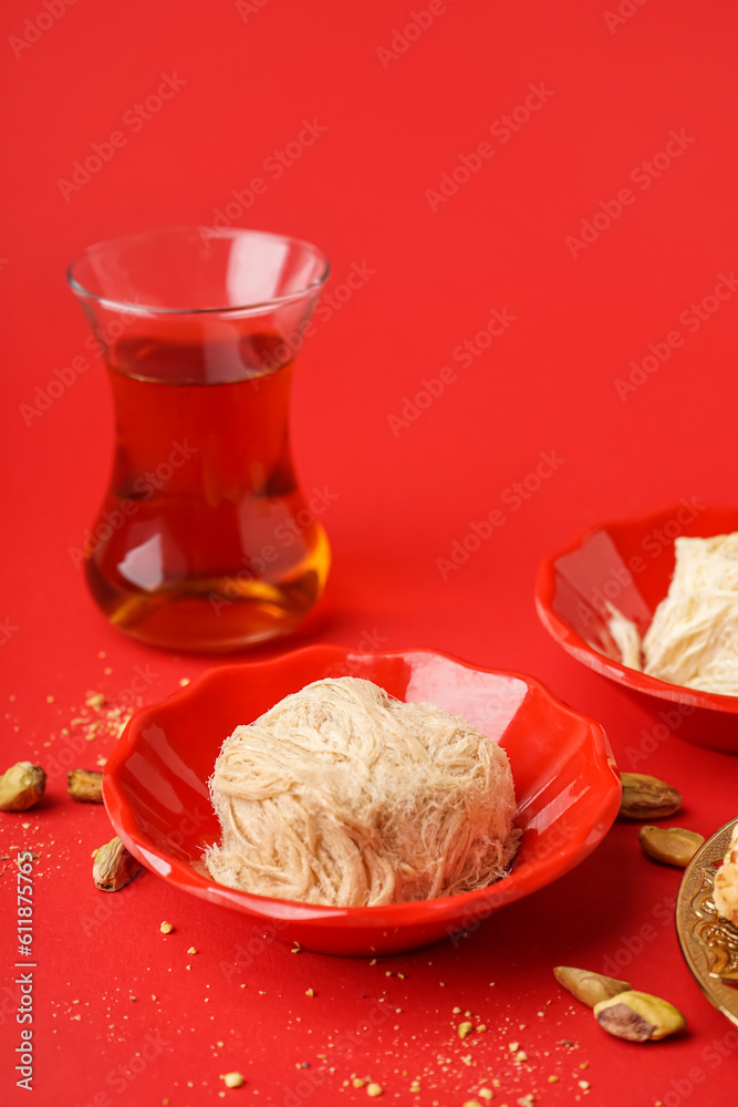 Bowl with tasty Turkish Pismaniye on red background