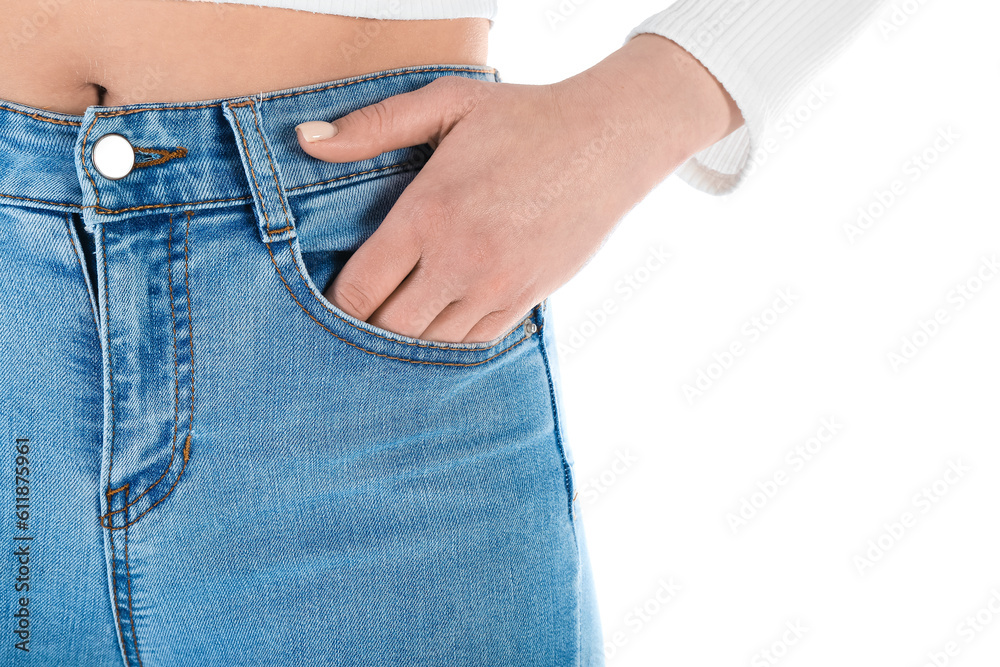 Young woman in skinny jeans on white background, closeup