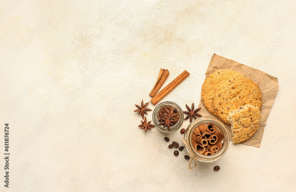 Composition with cinnamon sticks, anise stars and tasty cookies on light background