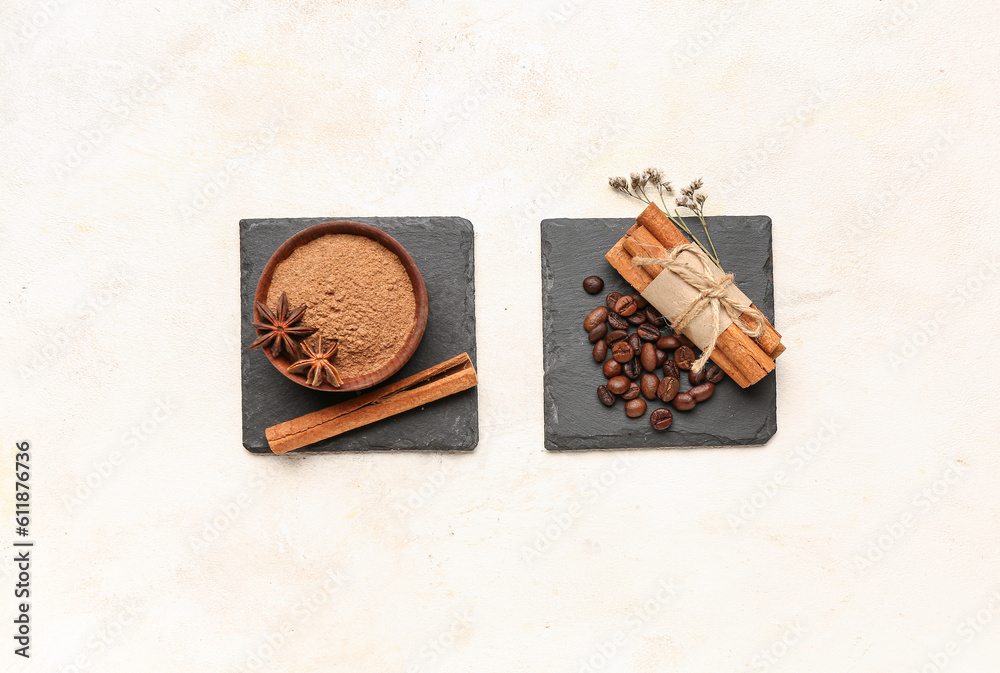 Composition with bowl of cinnamon powder, sticks and coffee beans on light background