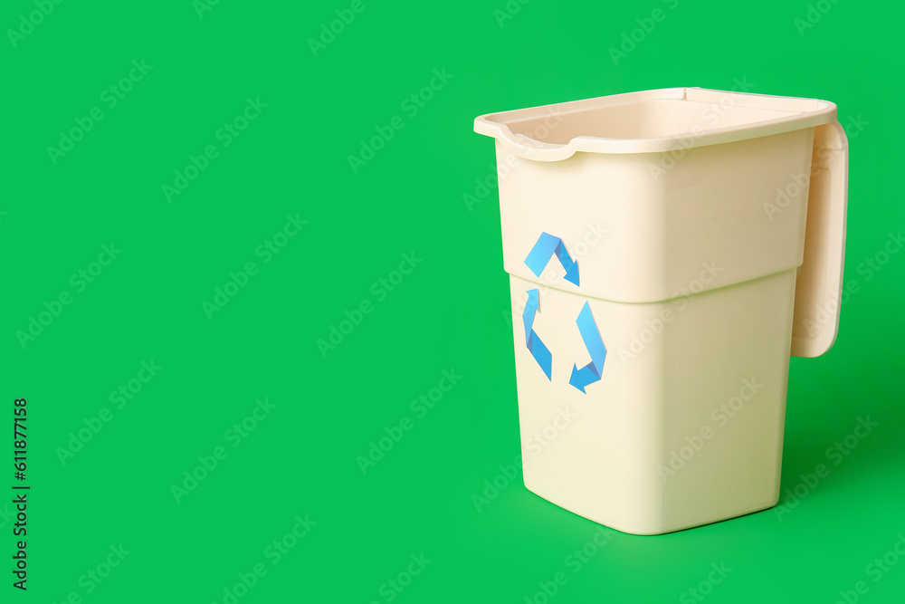 Container for garbage on green background. Recycling concept