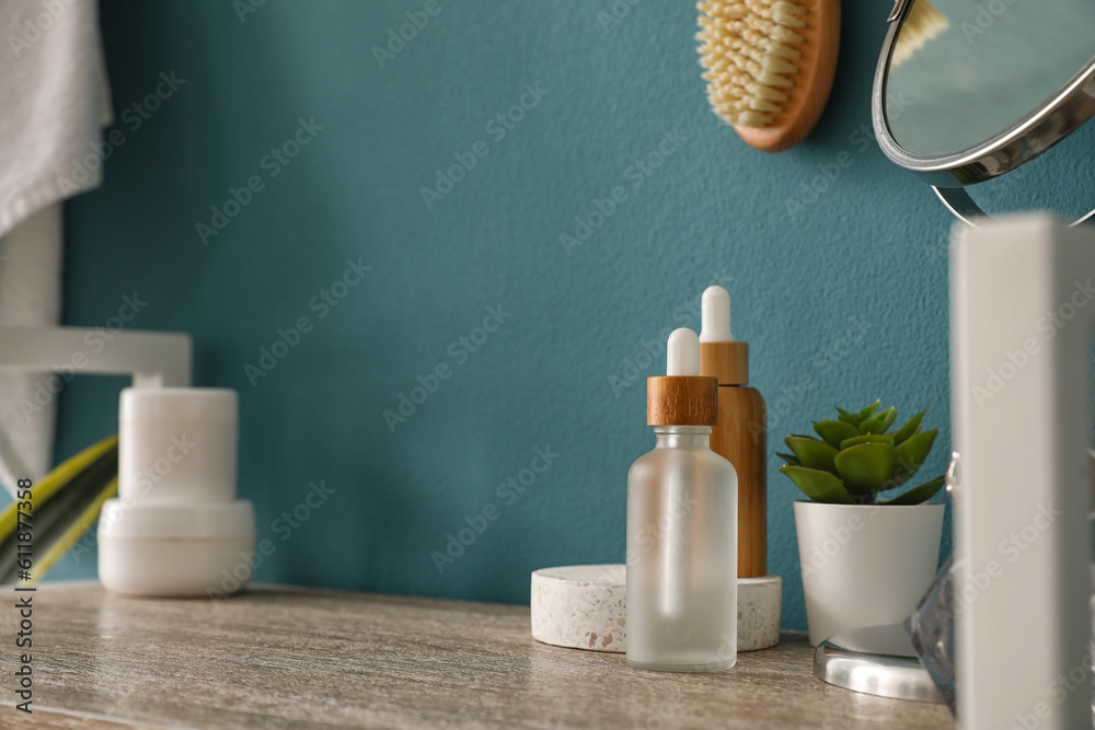 Bath accessories on shelf near blue wall