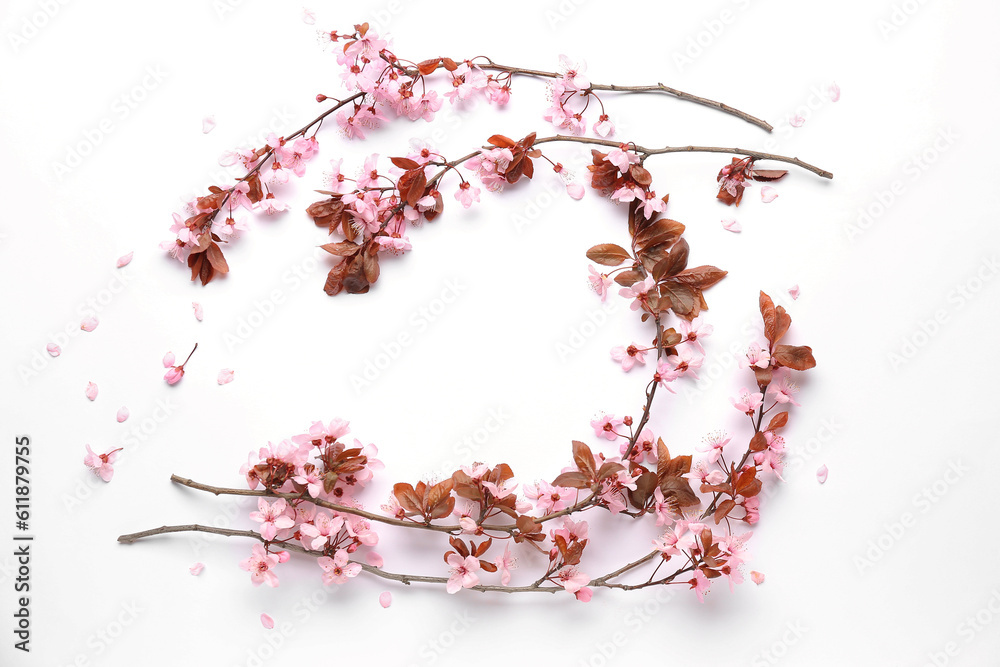 Frame made of blooming branches with pink flowers on white background