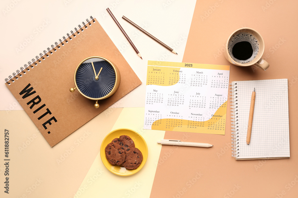 Composition with calendar, cup of coffee, cookies and alarm clock on colorful background