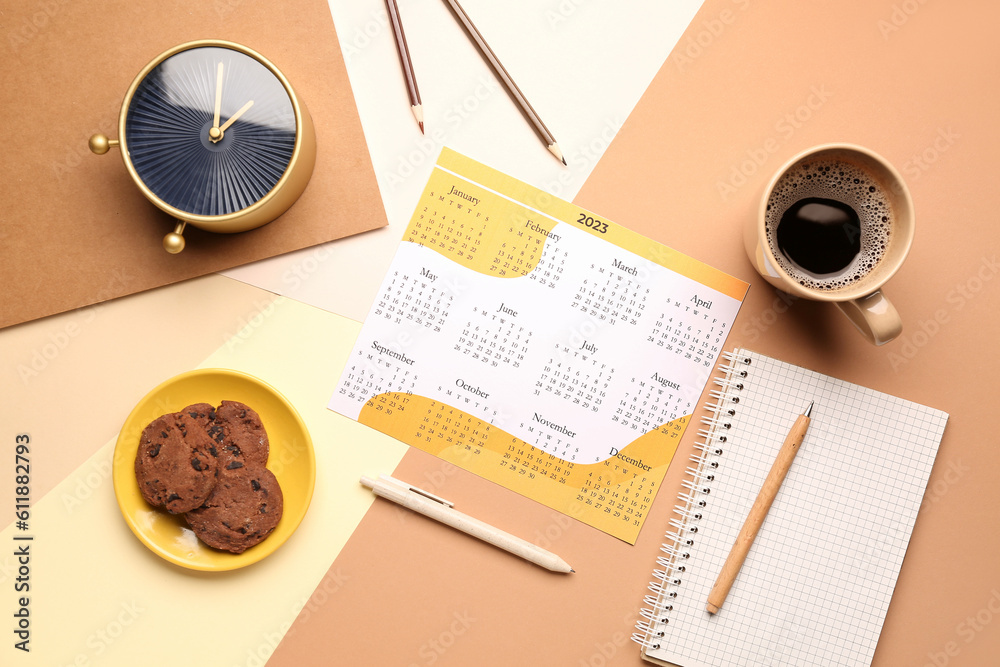 Composition with calendar, cup of coffee, cookies and alarm clock on colorful background