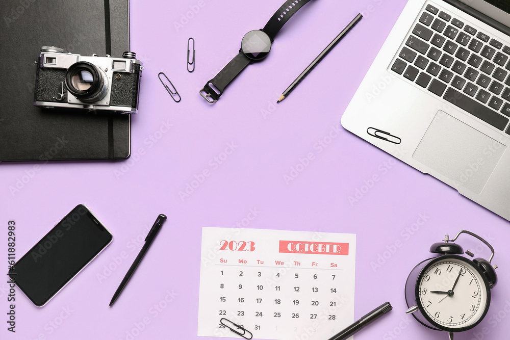 Composition with calendar, modern laptop, alarm clock, photo camera and mobile phone on lilac backgr