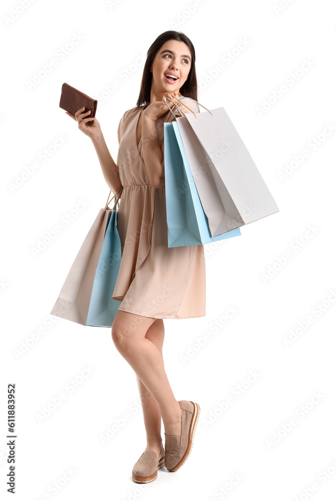 Young woman with shopping bags and wallet on white background