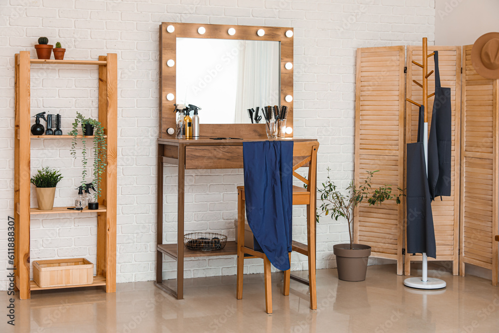 Interior of beauty salon with stylish table and folding screen