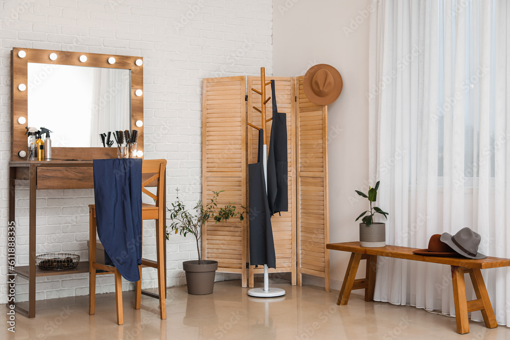 Interior of beauty salon with stylish table and folding screen