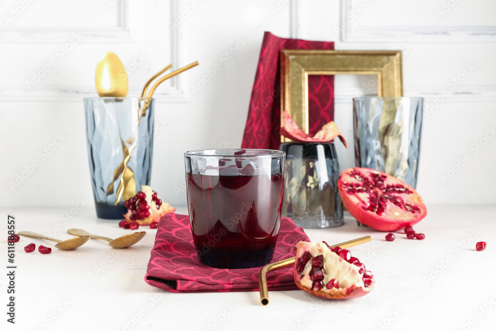 Glasses of fresh pomegranate juice on white table