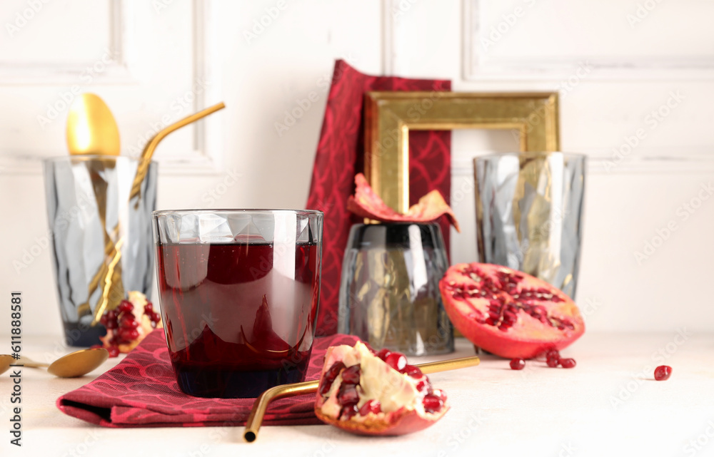 Glasses of fresh pomegranate juice on white table