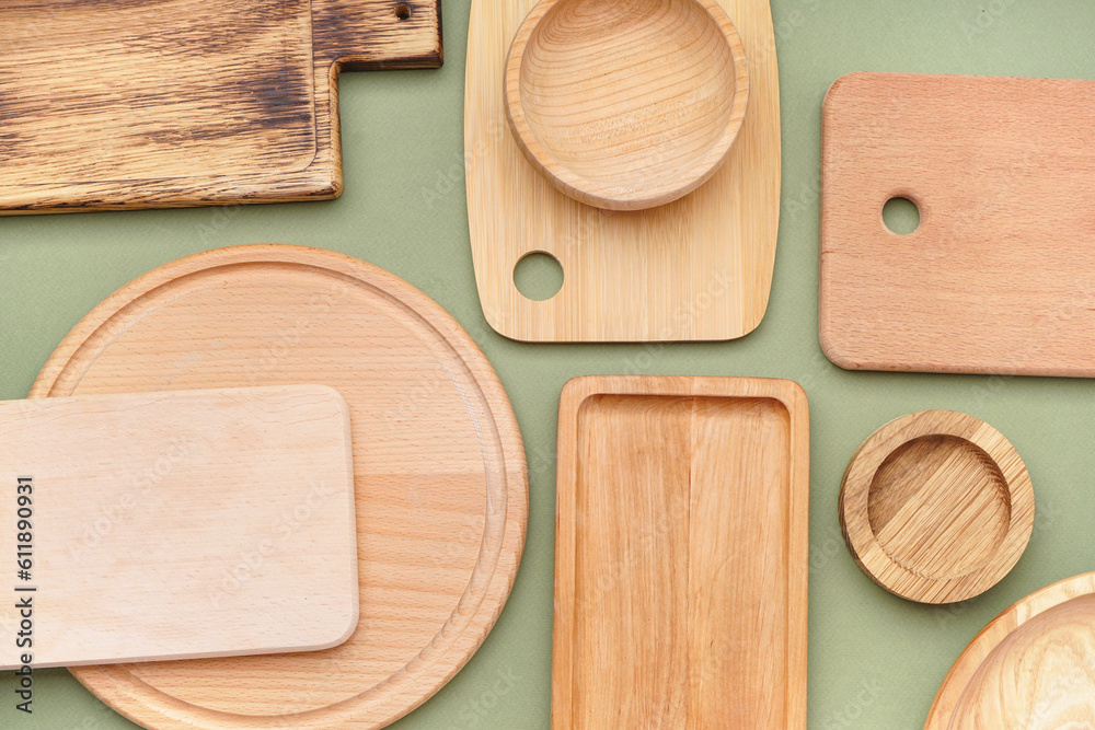 Different wooden cutting boards on olive background