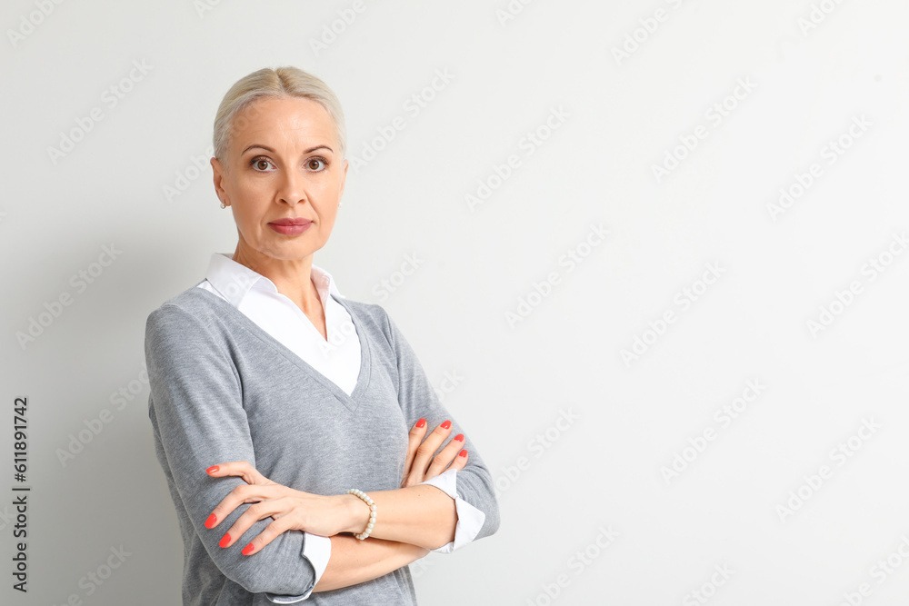 Mature blonde woman on light background