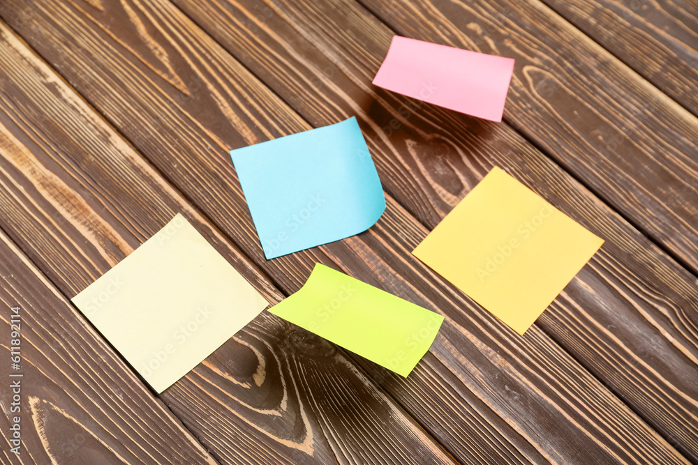 Sticky notes on brown wooden background