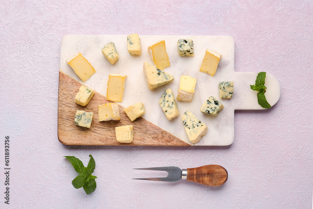 Board with pieces of tasty cheese on light background