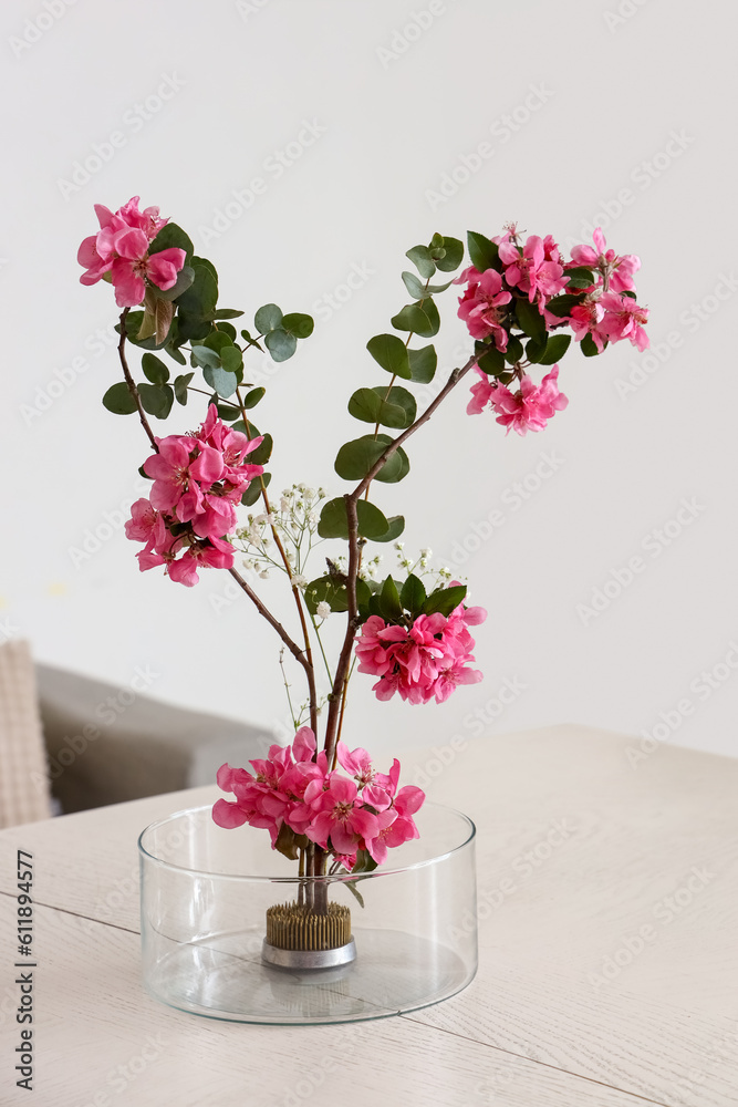 Beautiful ikebana on dining table in room