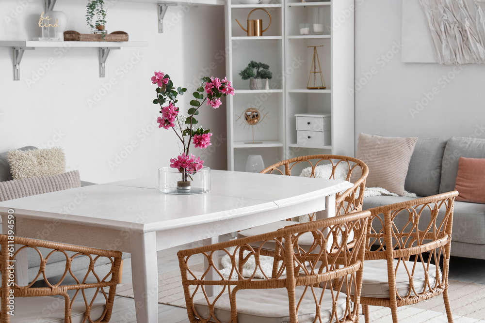 Beautiful ikebana on dining table in room