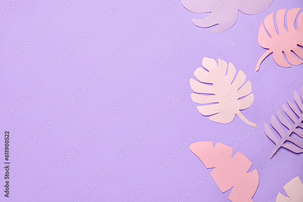 Different paper tropical leaves on lilac background