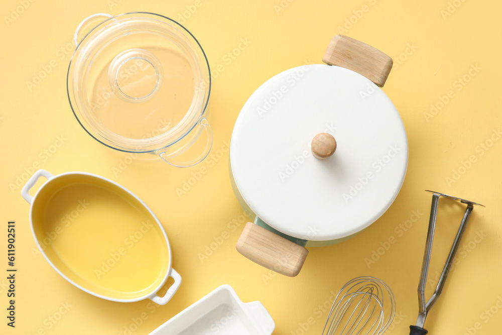 Set of different kitchen utensils on beige background