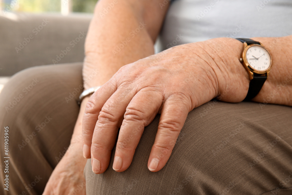 Senior woman sitting at home, closeup