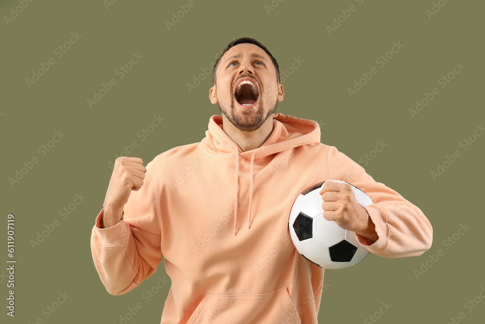 Screaming man with soccer ball on color background