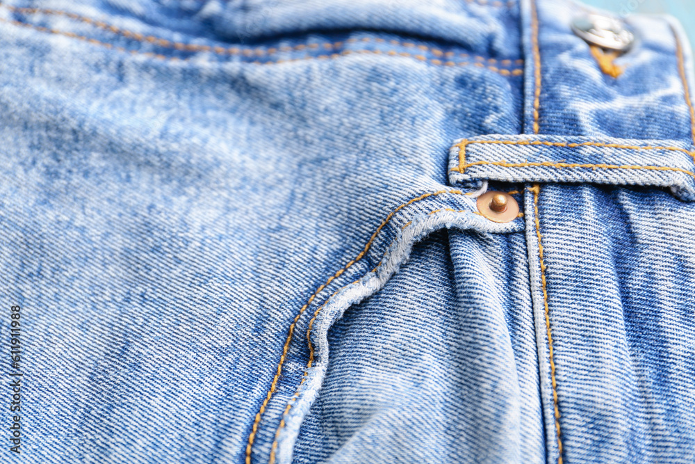 Stylish denim jeans as background, closeup