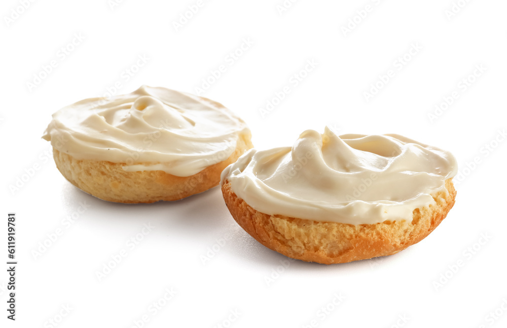 Tasty croutons with cream cheese on white background