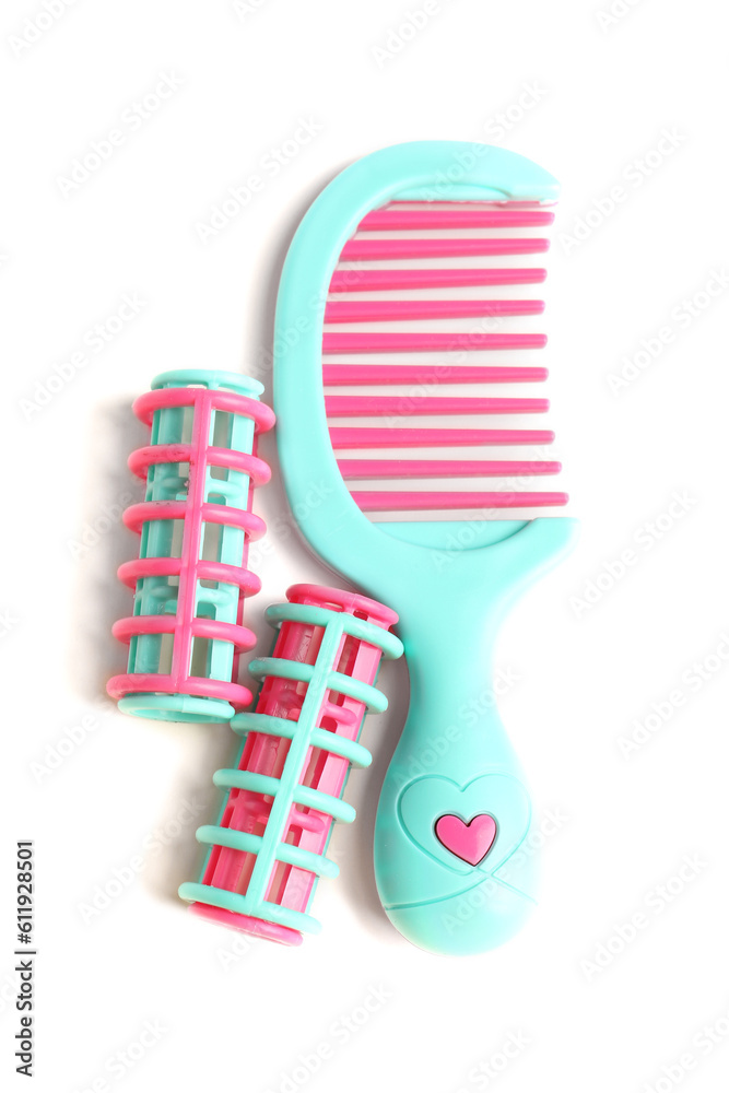 Colorful hair curlers and hair comb isolated on white background. Childrens Day celebration