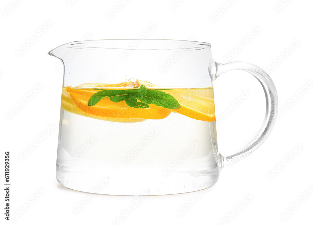 Glass jug of infused water with orange slices on white background