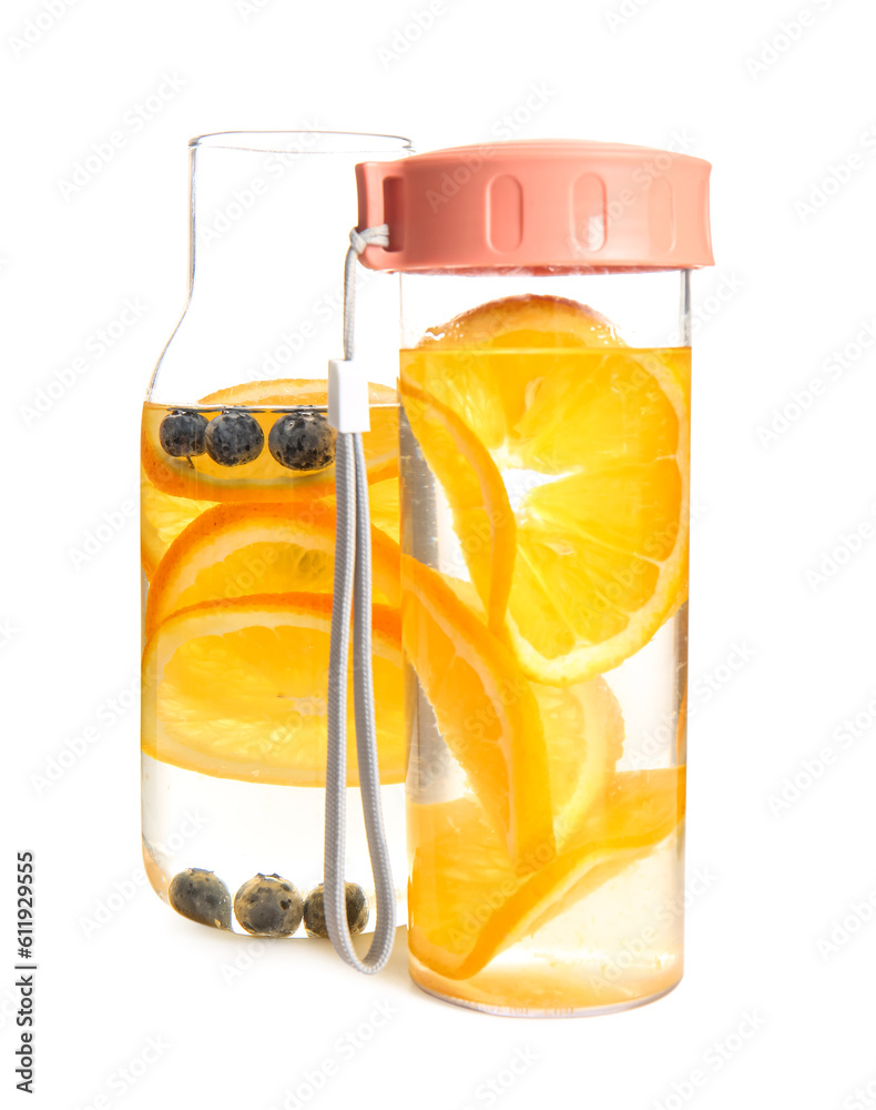 Bottles of infused water with orange slices on white background