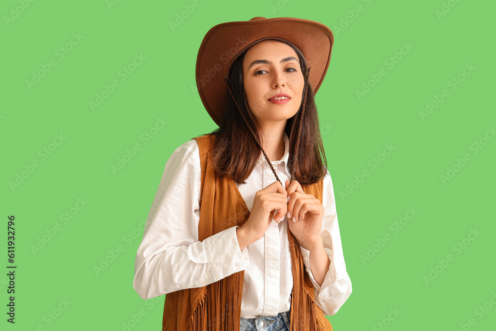 Beautiful cowgirl on green background