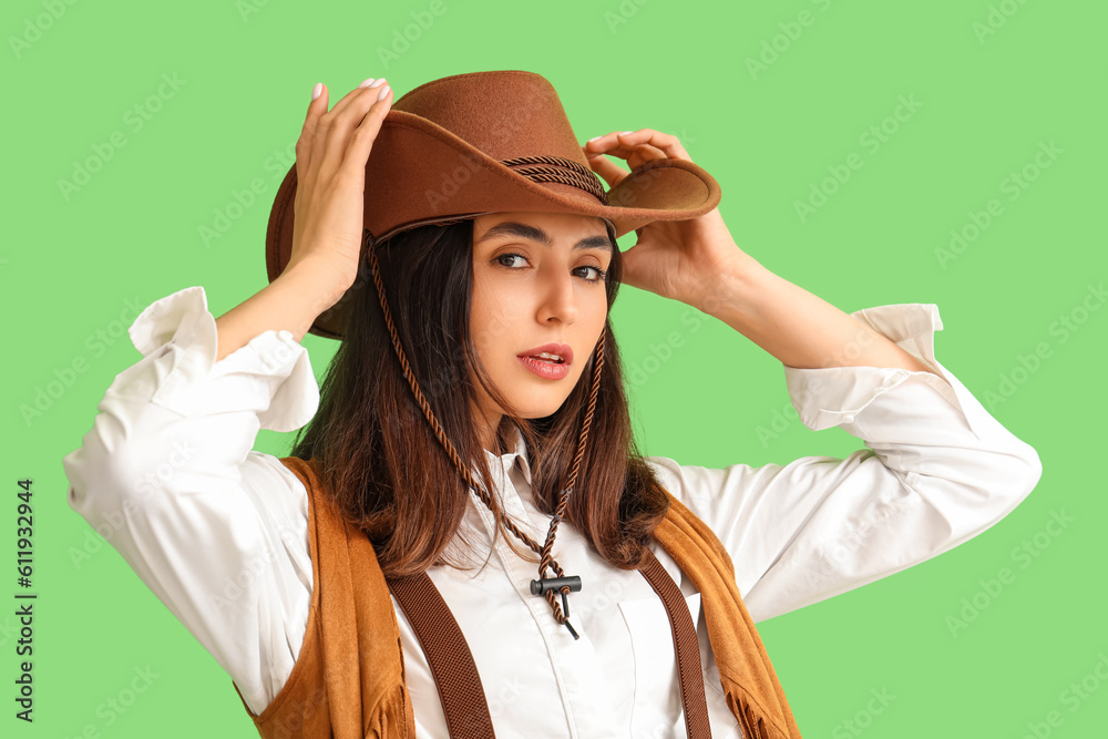 Beautiful cowgirl on green background, closeup