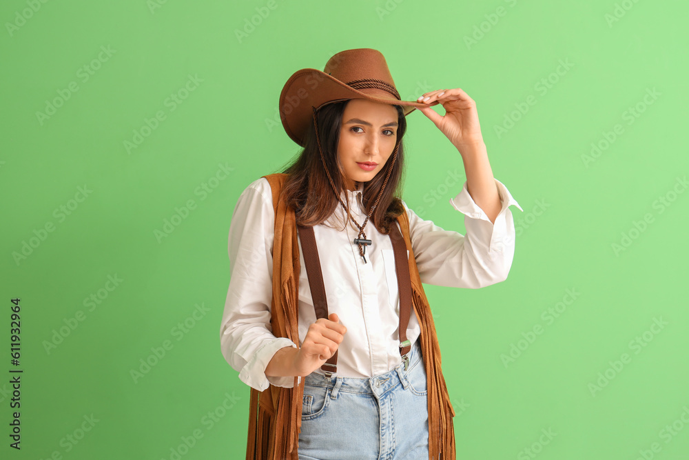 Beautiful cowgirl on green background