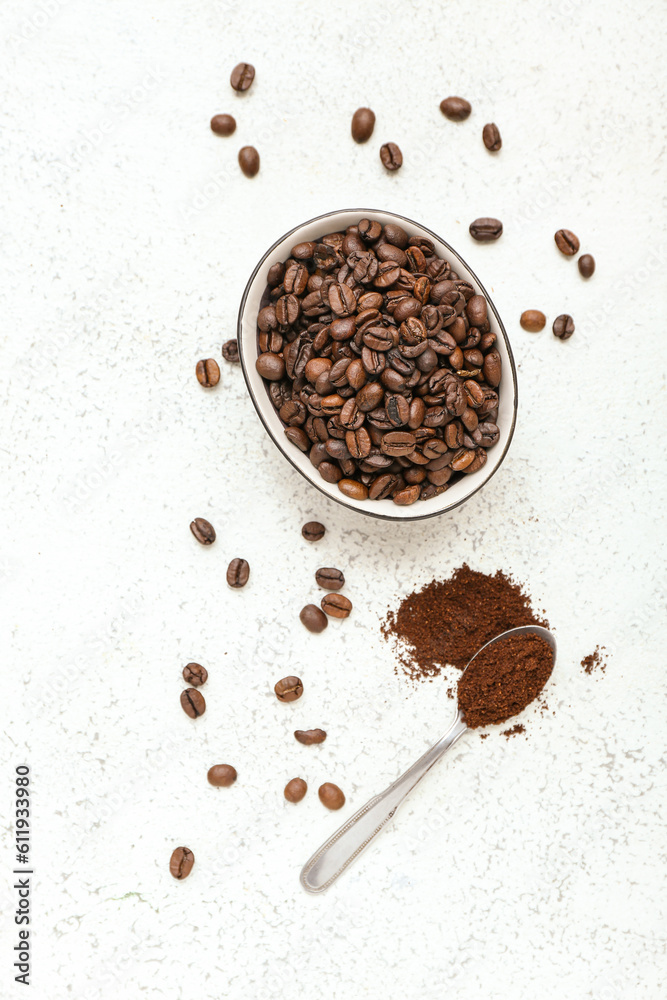 Bowl with coffee beans on light background