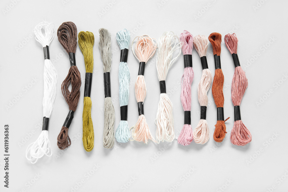 Different colorful mouline threads on white background