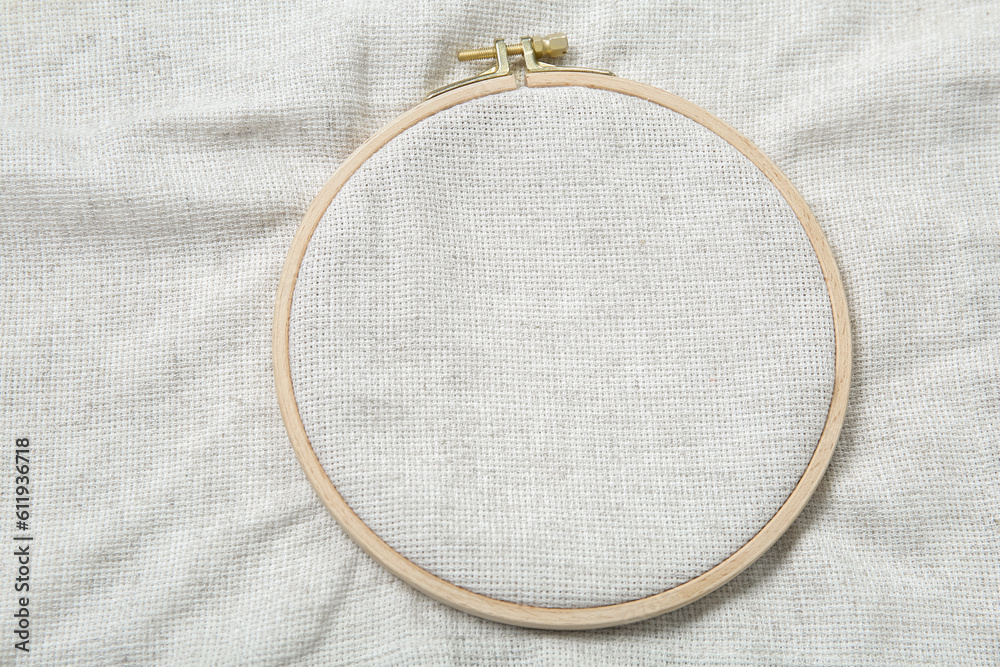 Wooden embroidery hoop with canvas as background