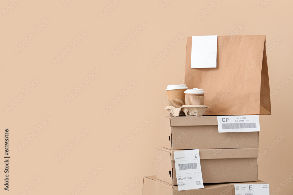 Parcels and containers with food on beige background