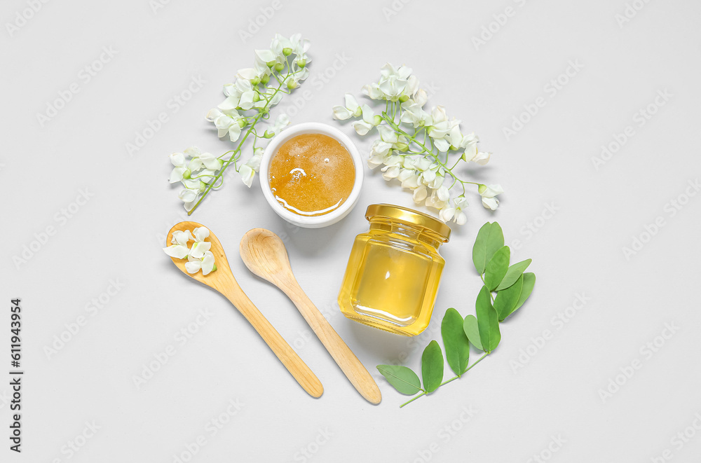 Composition with sweet honey and acacia flowers on white background