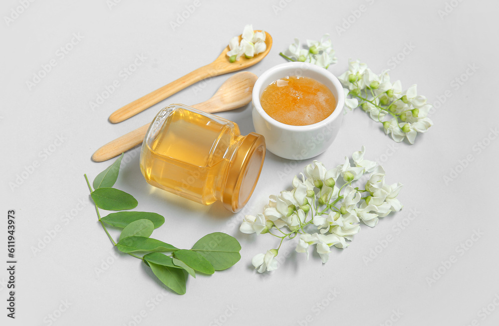 Composition with sweet honey and acacia flowers on white background