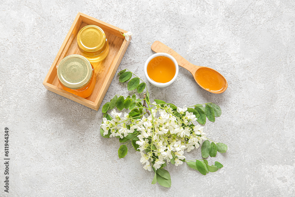 Composition with sweet honey and acacia flowers on light background