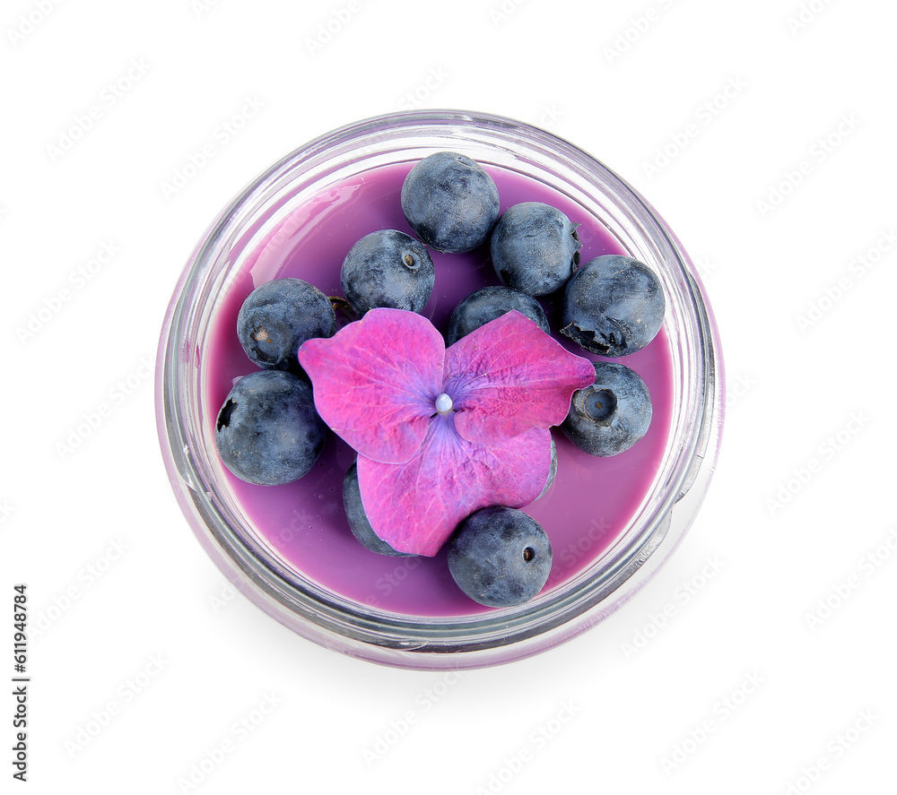 Glass jar of panna cotta with blueberry and beautiful hydrangea flower on white background