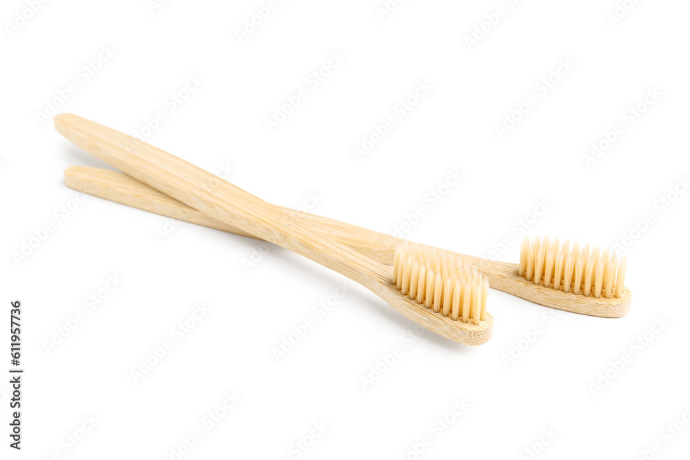 Bamboo toothbrushes on white background