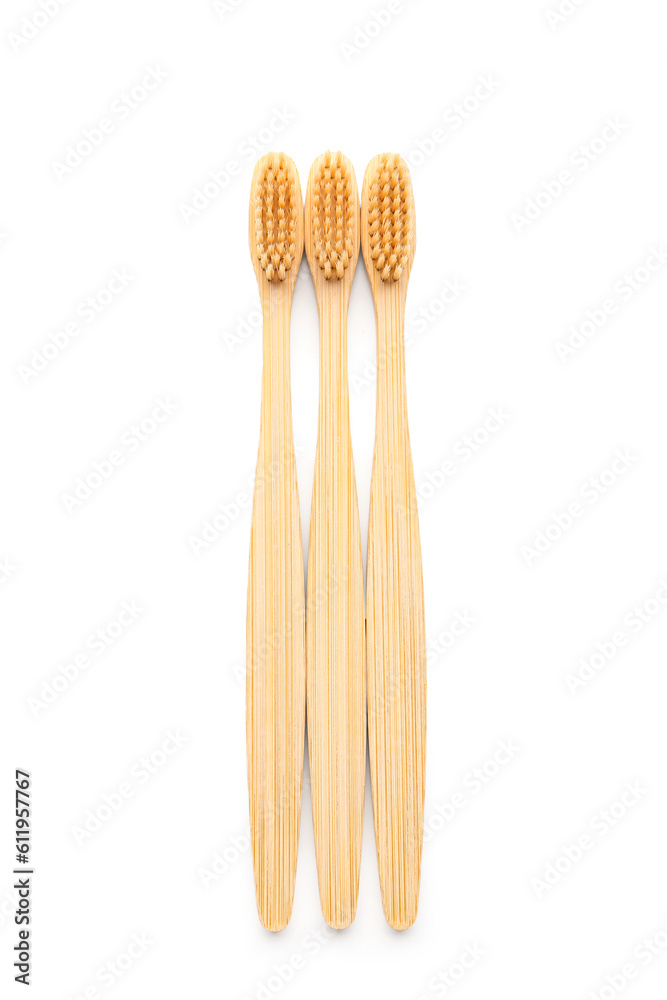 Bamboo toothbrushes on white background