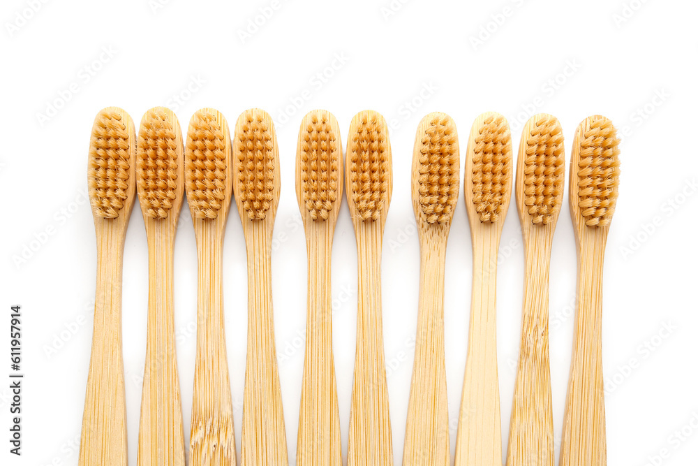 Many bamboo toothbrushes on white background