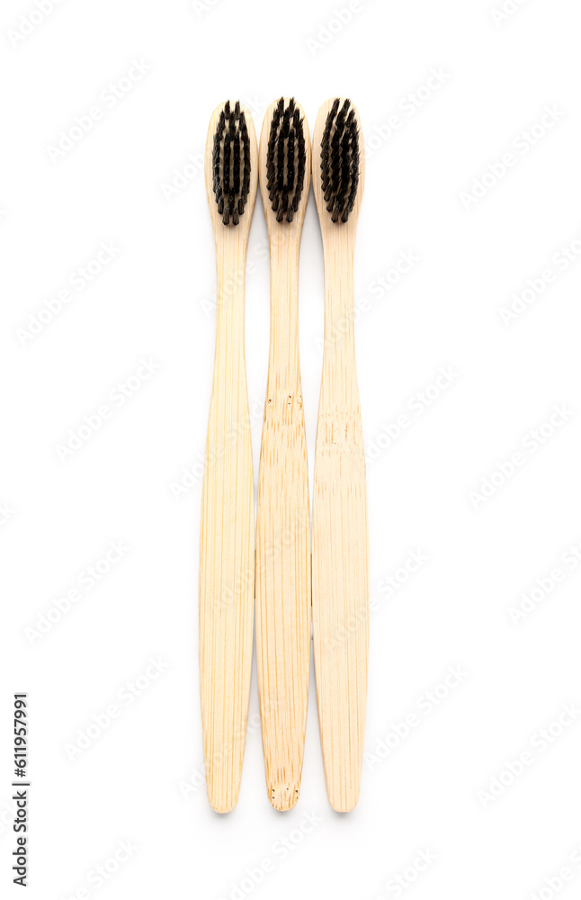 Bamboo toothbrushes on white background