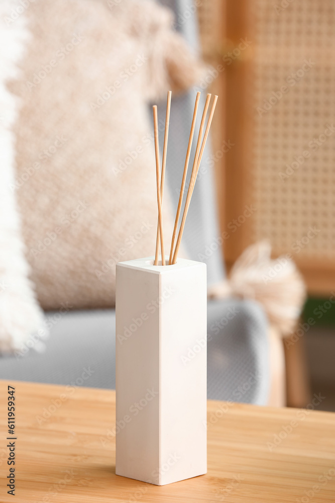 Bottle of reed diffuser on table, closeup