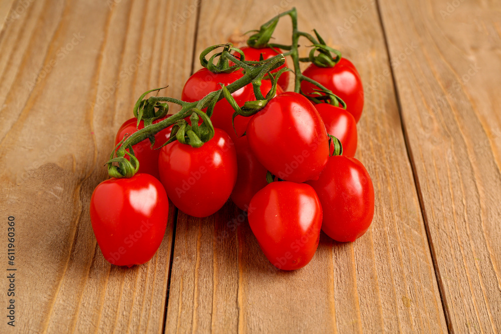 Fresh cherry tomatoes on wooden background