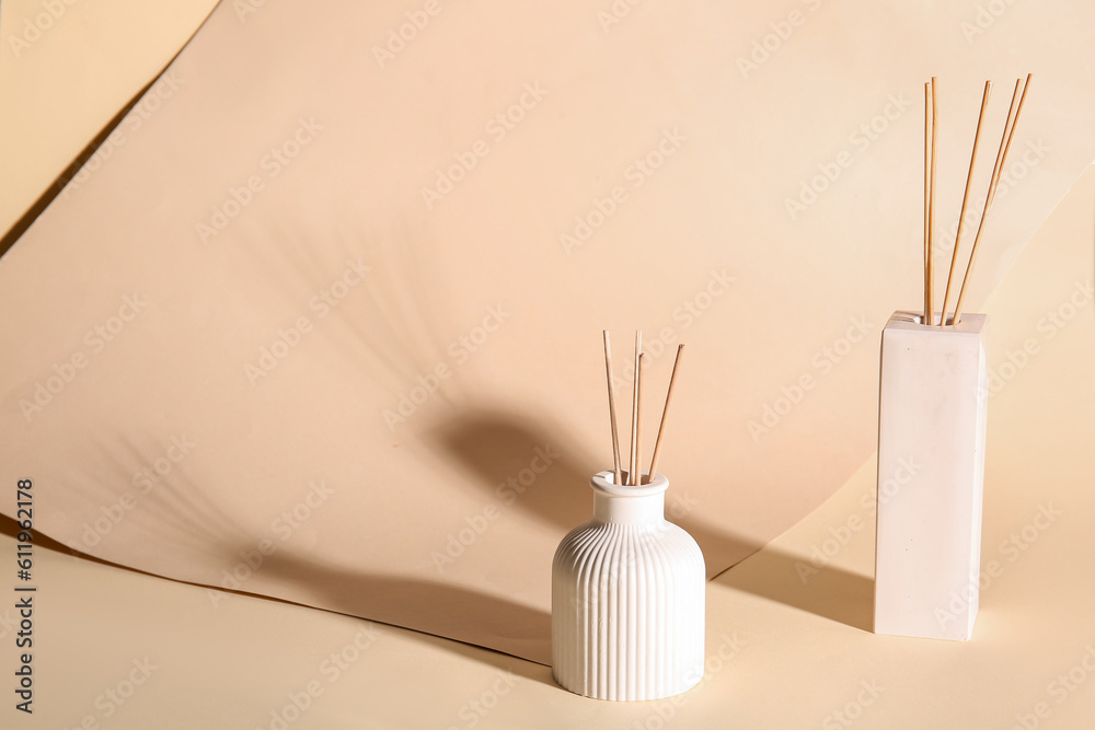 Bottles of reed diffuser on beige background